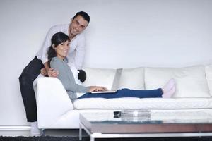 joyful couple relax and work on laptop computer at modern home photo