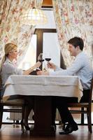 young couple having dinner at a restaurant photo