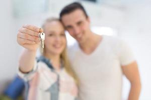 couple showing a keys of their new house photo