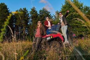 group young happy people enjoying beautiful sunny day while driving a off road buggy car photo