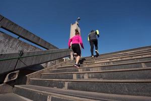 young  couple jogging on steps photo