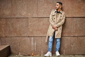 Stylish kuwaiti man at trench coat. photo