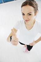 happy diet concept with young woman on pink scale photo