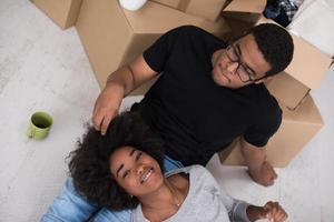 African American couple relaxing in new house photo