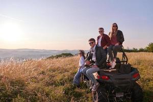 group young happy people enjoying beautiful sunny day while driving a off road buggy car photo