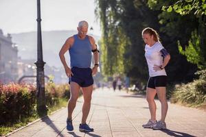 jogging couple planning running route  and setting music photo