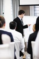 Young  business man giving a presentation on conference photo