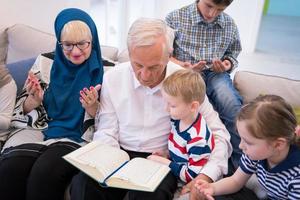 modern muslim grandparents with grandchildren reading Quran photo