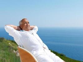 senior man sitting outside photo