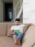 man using tablet computer from home photo