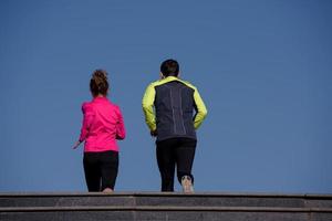 young  couple jogging on steps photo