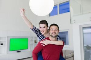 handsome man piggybacking his girlfriend photo