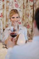 young couple having dinner at a restaurant photo