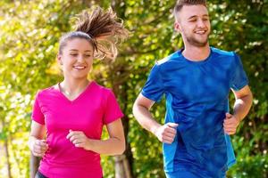 young couple jogging on sunny day at nature photo