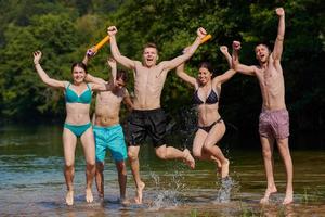 group of happy friends having fun on river photo