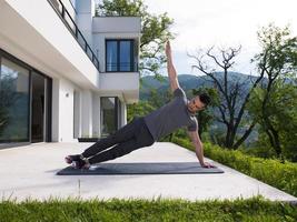 man doing morning yoga exercises photo