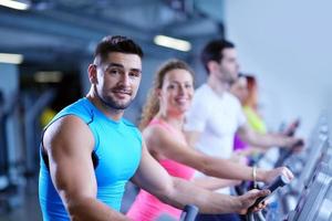 Group of people running on treadmills photo