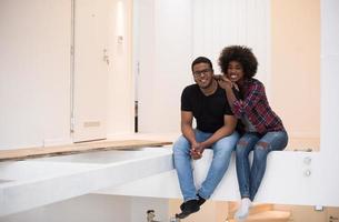 couple having break during moving to new house photo