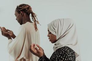 Handsome Young African Muslim Man And Muslim Hijab Woman Making Traditional Fatiha Prayer To Allah God While Wearing A Traditional Sudan fashion clothes in studio photo