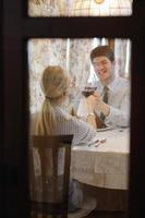 young couple having dinner at a restaurant photo