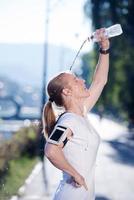 woman drinking  water after  jogging photo