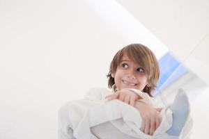 portrait of little arabian boy sitting on the glass floor photo