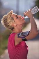 woman drinking  water after  jogging photo