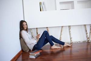 relaxed young woman at home working on laptop computer photo