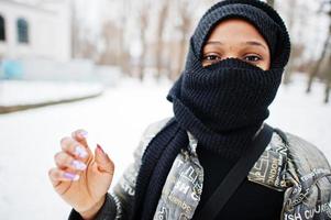 African muslim woman wear in black hijab scarf pose in winter day at Europe. photo