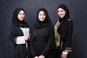 portrait of beautiful muslim women in fashionable dress photo