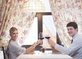 young couple having dinner at a restaurant photo