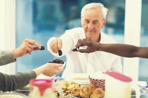 modern multiethnic muslim family sharing a bowl of dates photo