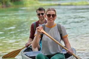 friends are canoeing in a wild river photo