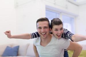 handsome man piggybacking his girlfriend photo