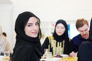 young muslim woman having Iftar dinner with family photo