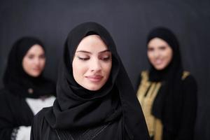 portrait of beautiful muslim women in fashionable dress photo