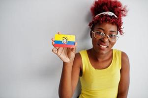 African american woman with afro hair, wear yellow singlet and eyeglasses, hold Ecuador flag isolated on white background. photo