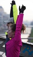 couple warming up before jogging photo