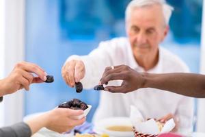 modern multiethnic muslim family sharing a bowl of dates photo