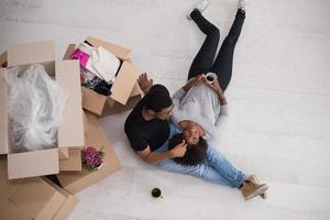 African American couple relaxing in new house photo