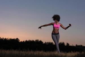 black woman is doing stretching exercise relaxing and warm up photo