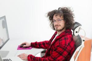 graphic designer in bathrobe working at home photo