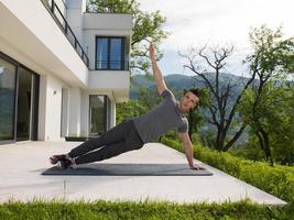 man doing morning yoga exercises photo