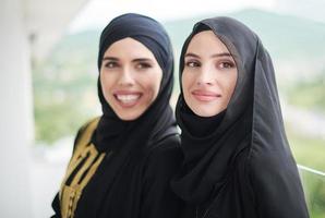 portrait of beautiful muslim women standing on balcony photo