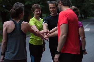 runners giving high five to each other photo