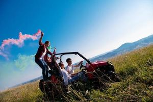 group of young people having fun while driving a off road buggy car photo