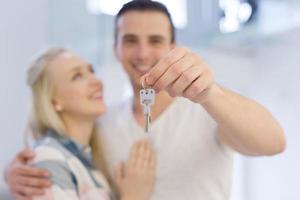 couple showing a keys of their new house photo