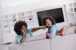 young multiethnic couple in living room photo