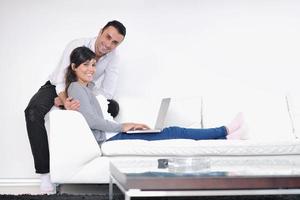 joyful couple relax and work on laptop computer at modern home photo