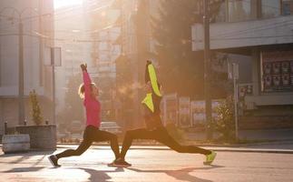 couple warming up before jogging photo